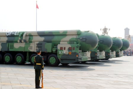 FILE PHOTO: Military vehicles carrying DF-41 intercontinental ballistic missiles travel past Tiananmen Square during the military parade marking the 70th founding anniversary of People&#39;s Republic of China