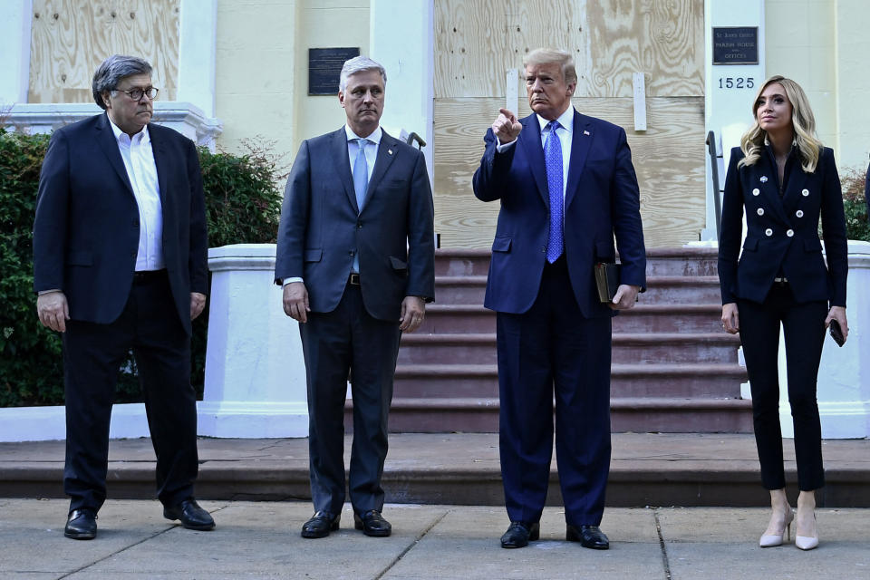 President Donald Trump holds up a Bible alongside Attorney General William Barr (left), White House national security adviser Robert O&rsquo;Brien and White House press secretary Kayleigh McEnany, outside of St. John's Episcopal Church across Lafayette Park in Washington, D.C., on June 1. (Photo: BRENDAN SMIALOWSKI via Getty Images)
