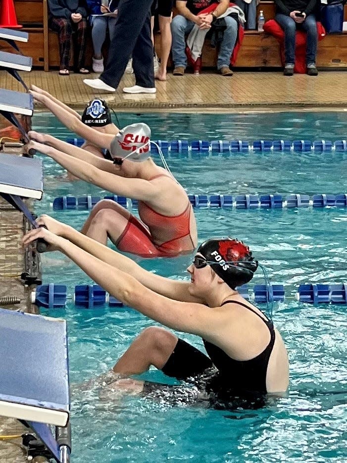 Stephanie Foos of Pleasant gets set to swim the backstroke in the 200-yard medley relay during the Mid Ohio Athletic Conference Swimming Championships this winter at Ontario. Foos was a part of the Marion Dolphins program at the YMCA this summer.
