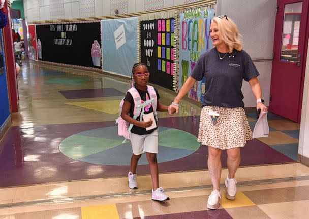 PHOTO: Avery Hill holds hands with art teacher Melony Maughn as she looks for her class while parents and children arrive for the first day of the 2022-23 school year in Tuscaloosa, Ala., Aug. 10, 2022. (Gary Cosby Jr./The Courier-Journal via USA Today Network)