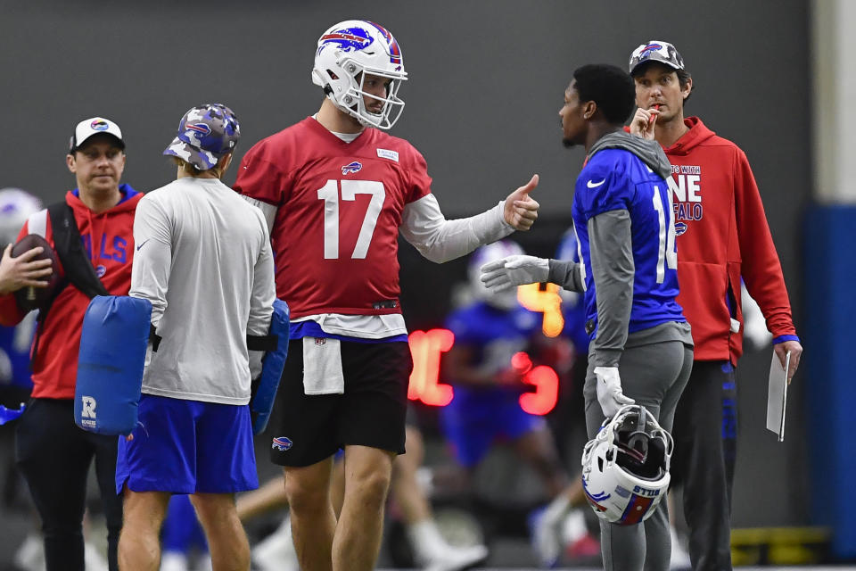 Buffalo Bills quarterback Josh Allen (17) talks with wide receiver Stefon Diggs as offensive coordinator Ken Dorsey, right, looks on during an NFL football practice in Orchard Park, N.Y., Thursday, Jan. 12, 2023. (AP Photo/Adrian Kraus)