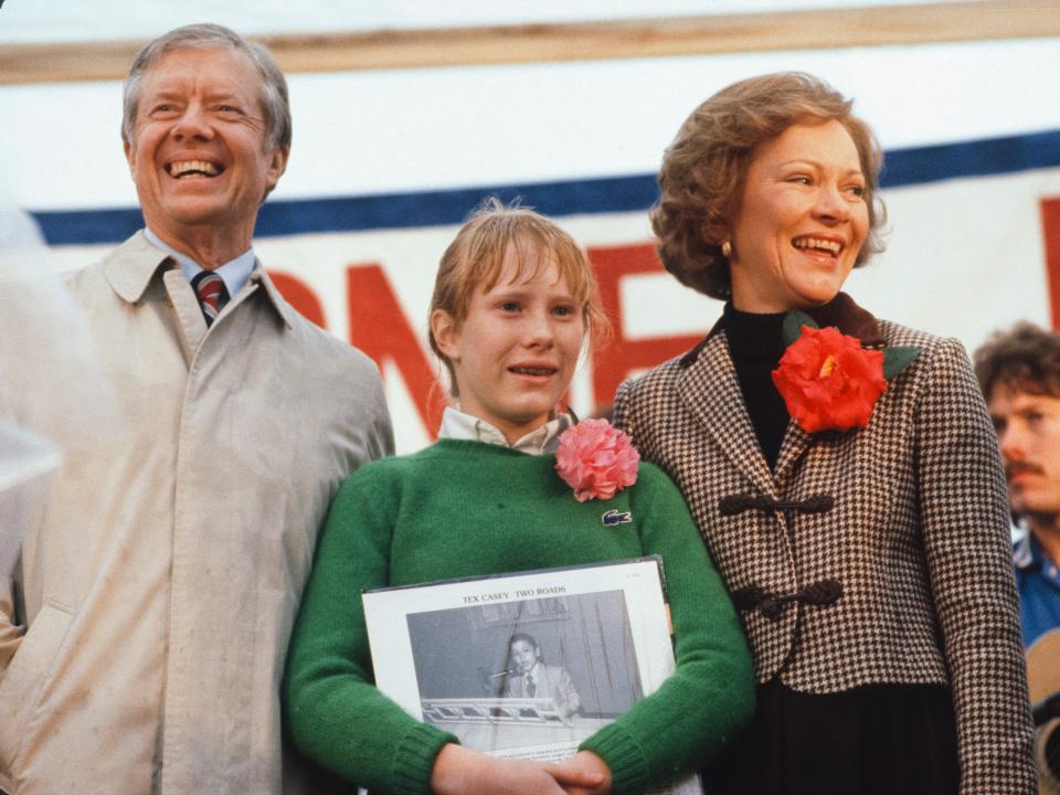 Jimmy, Rosalynn, and Amy Carter smile at the crowds following their return to Plains, Georgia, after leaving the White House in 1981.