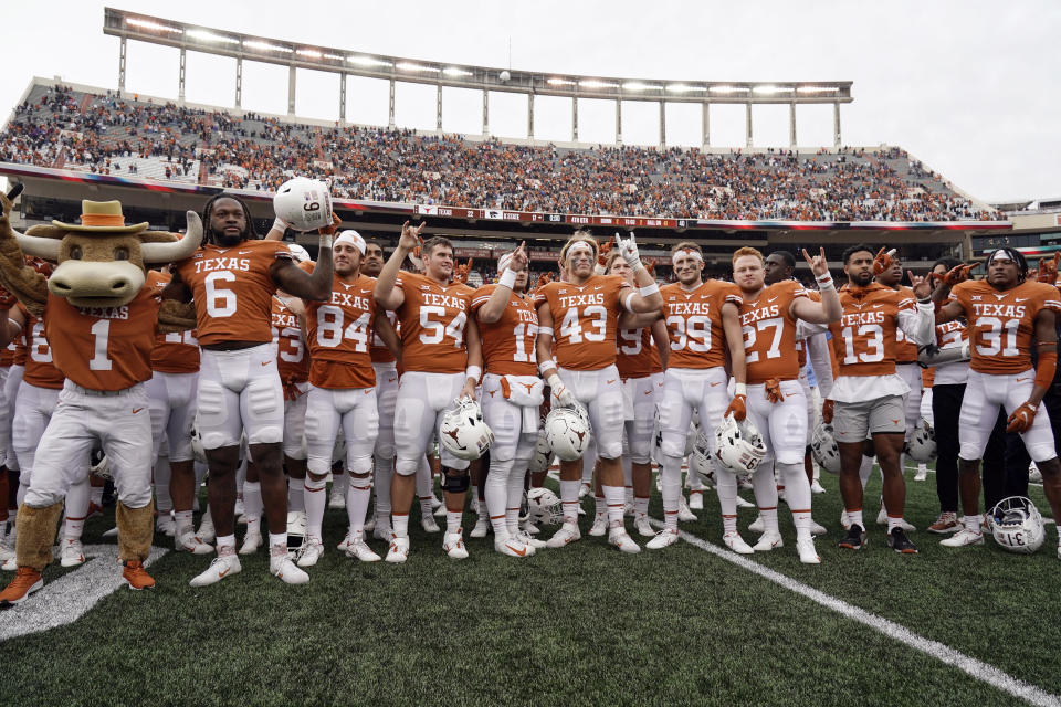 FILE - Texas players sing "The Eyes Of Texas" after defeating Kansas State in an NCAA college football game in Austin, Texas, Nov. 26, 2021. Texas is one of several states that legally ban using endorsement contracts as pay for play or recruiting, but have shown no interest in questioning the deals, school officials or third-party groups that set them up. (AP Photo/Chuck Burton, File)