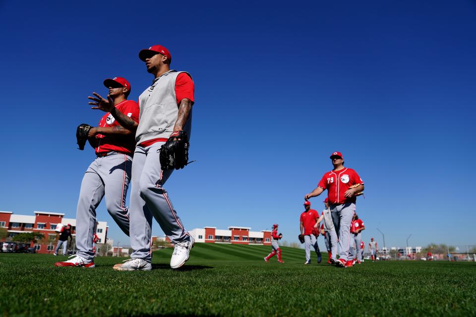 Cincinnati Reds relief pitcher Fernando Cruz (63), left, and Cincinnati Reds starting pitcher Frankie Montas (47), walk between drills during spring training workouts, Wednesday, Feb. 14, 2024, at the team’s spring training facility in Goodyear, Ariz.