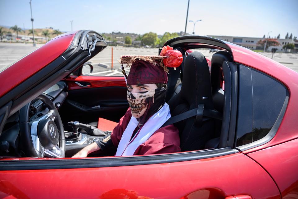 Mount San Antonio College graduating student Scott Macias arrives to receive his diploma from his car window at the school's first drive-thru commencement ceremony, June 18, 2020 in Walnut, California. (Photo: ROBYN BECK/AFP via Getty Images)