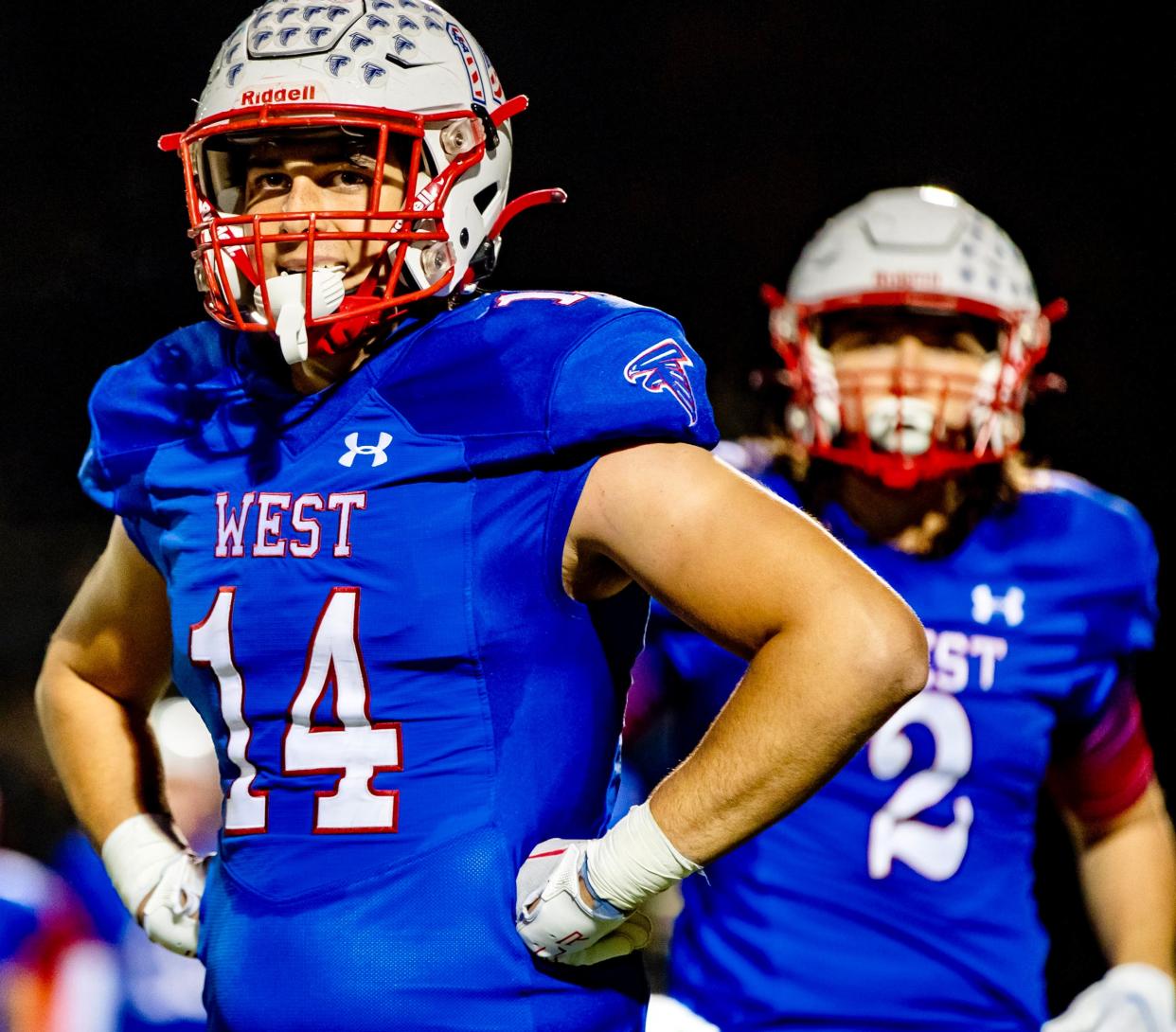 West Henderson sophomore receiver Tyler Nash (14) and senior tight end Cameron Banks (2) look to the sidelines as the Falcons face Tuscola Friday night during the final game of the regular season at West Henderson High School in Hendersonville, NC. West defeated Tuscola 55-7.