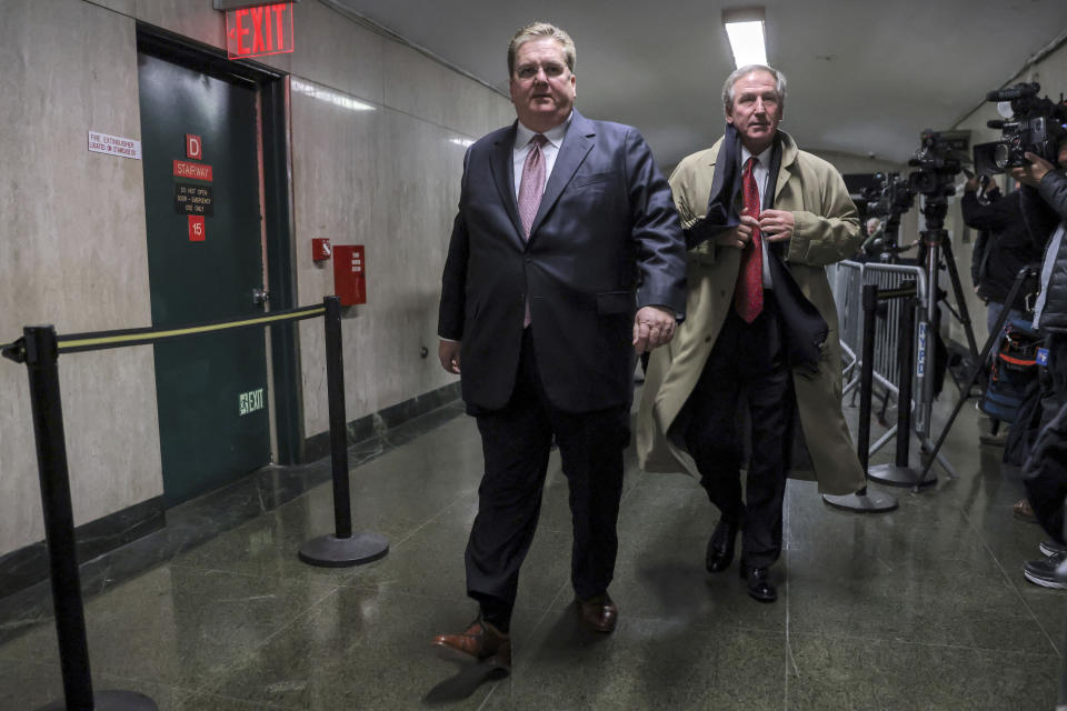 Defense attorneys Michael van der Veen, right, and William Brennan, left, leave the courtroom during jury deliberation in the Trump Organization tax fraud case, Tuesday, Dec. 6, 2022, in New York. (AP Photo/Julia Nikhinson)