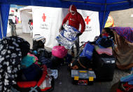 <p>Venezuelan migrants wait to be assisted by the Ecuadorian Red Cross at the Rumichaca International Bridge in Ecuador, Aug. 17, 2018. (Photo: Luisa Gonzalez/Reuters) </p>