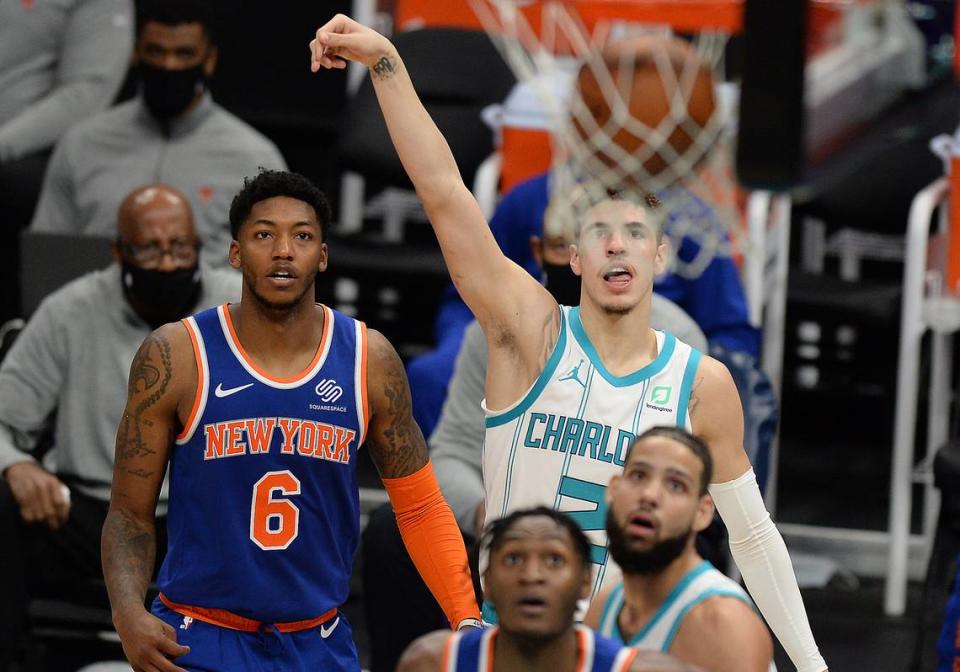 Charlotte Hornets guard LaMelo Ball, extends his right arm as he watches his three-point attempt go through the net against the New York Knicks on Jan. 11th.