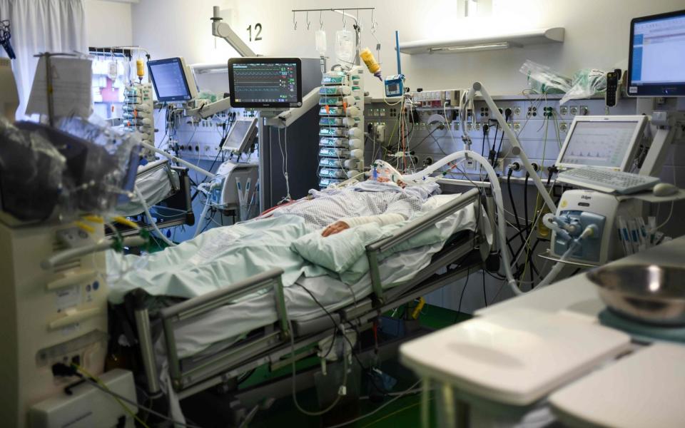 A Covid-19 patient is seen in the intensive care unit of the University hospital of Aachen, western Germany, on November 10, 2020 amid the novel coronavirus COVID-19 pandemic. - According to the Intensive Care Register of the Association for Intensive and Emergency Medicine, the number of corona patients receiving intensive care treatment rose on November 10, 2020 by 54 to 3059 compared to the previous day. Of these, 1737 received invasive ventilation, 49 more than the day before. (Photo by Ina FASSBENDER / AFP) (Photo by INA FASSBENDER/AFP via Getty Images) - INA FASSBENDER/AFP