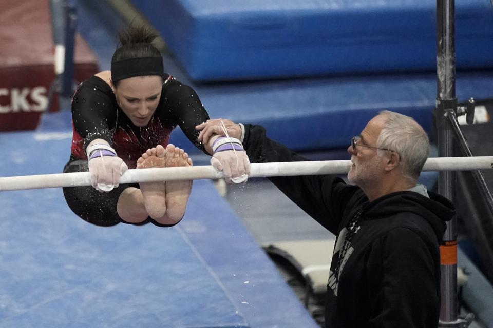 Former world champion and Olympic silver medalist Chellsie Memmel works out with her father and coach Andy Memmel Thursday, Feb. 18, 2021, in New Berlin, Wisc. (AP Photo/Morry Gash)