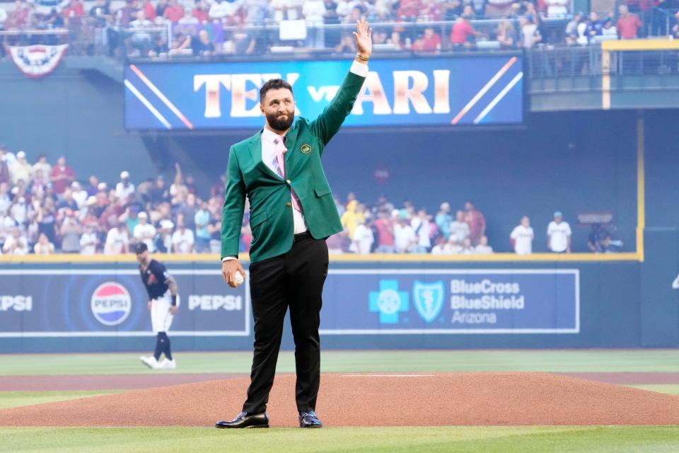 Spanish professional golfer and Arizona State University alumnus Jon Rahm acknowledges the crowd before throwing out the ceremonial first pitch before Game 4 of the World Series between the Arizona Diamondbacks and Texas Rangers at Chase Field in Phoenix on October 31, 2023.