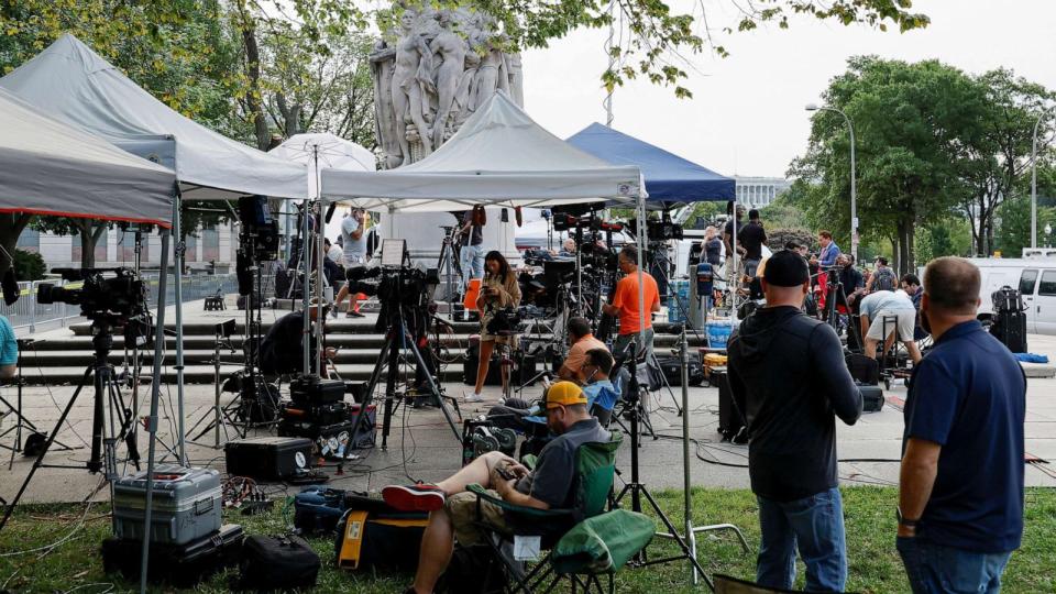 PHOTO: Media members prepare for the arrival of former President Donald Trump, who is facing federal charges in connection with attempts to overturn his 2020 election defeat, at U.S. District Court in Washington, D.C., Aug. 3, 2023. (Jonathan Ernst/Reuters)