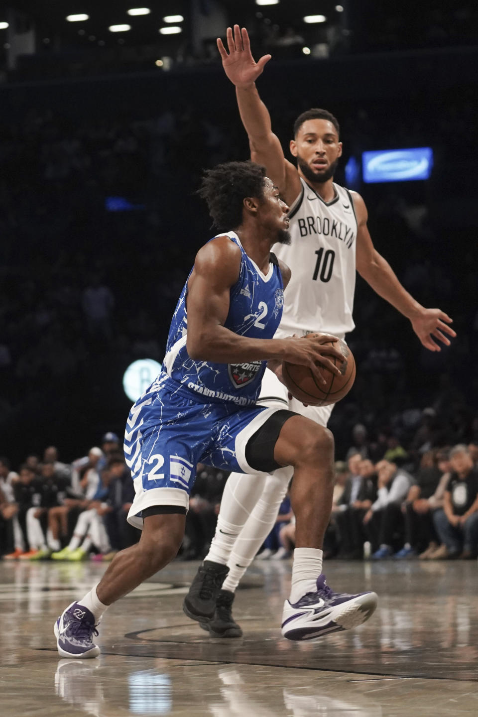 Maccabi Ra'anana's Ashton Hagans, left, drives past Brooklyn Nets' Ben Simmons, right, during a preseason NBA basketball game, Thursday, Oct. 12, 2023, in New York. (AP Photo/Bebeto Matthews)