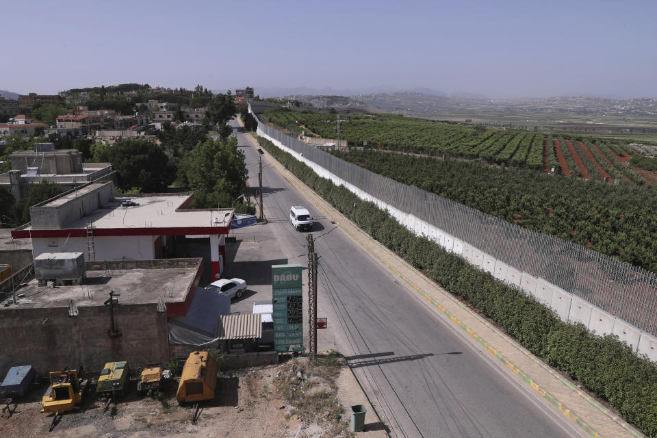 A car drives along the village of Kfar Kila on the Lebanese-Israeli border in southeast Lebanon, Wednesday, May 20, 2020. Twenty years after Hezbollah guerrillas pushed Israel's last troops from southern Lebanon, both sides are gearing up for a possible war that neither seems to want. (AP Photo/Bilal Hussein)