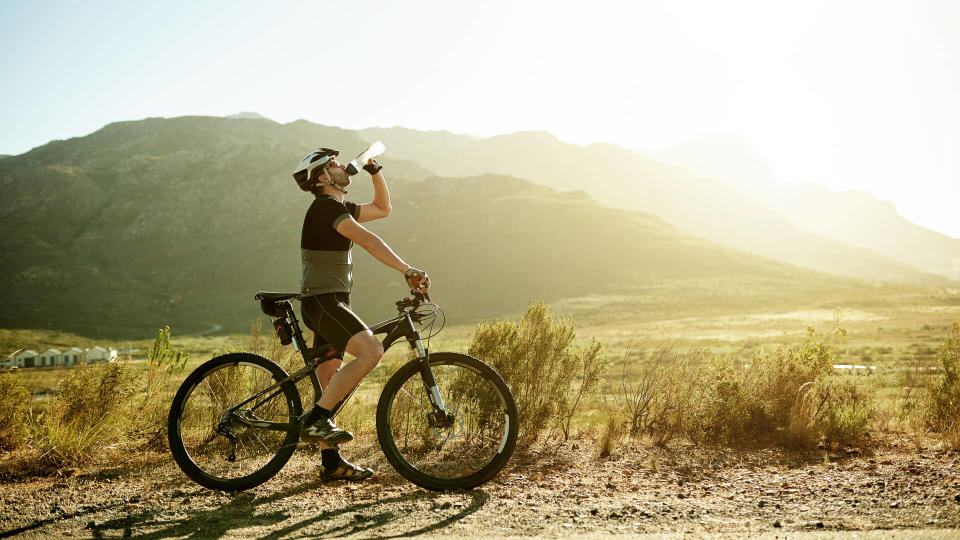 Shot of a mature man having a water break while out for a ride on his mountain bike.