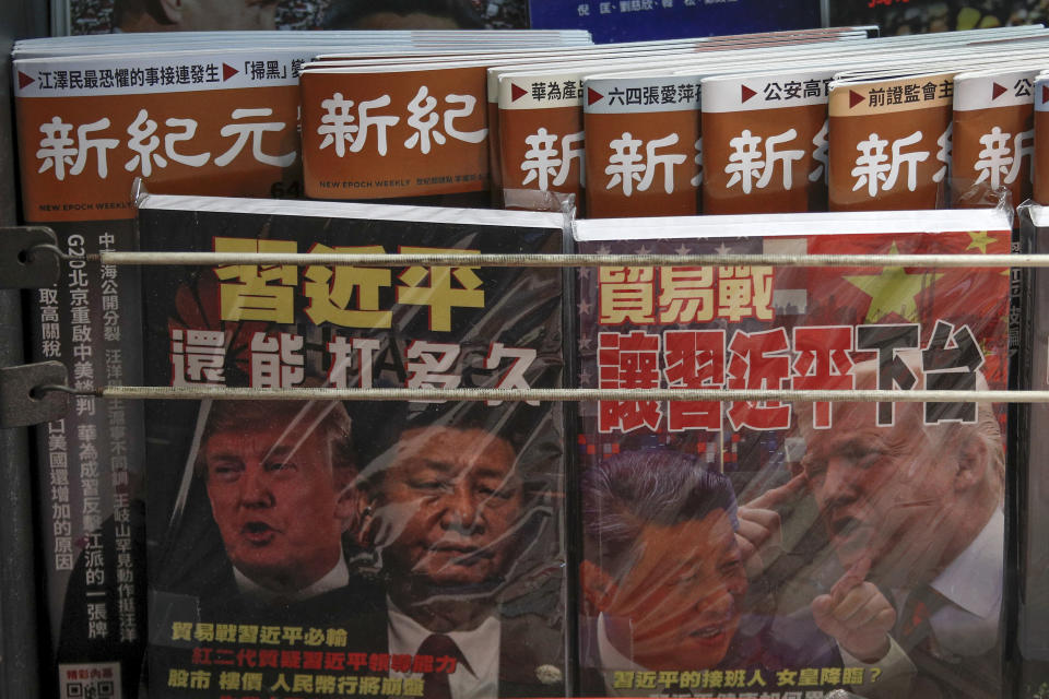 In this July 4, 2019, photo, Chinese magazines with front covers featuring Chinese President Xi Jinping and U.S. President Donald Trump on trade war is placed on sale at a roadside bookstand in Hong Kong. Facing another U.S. tariff hike, Xi is getting tougher with Washington instead of backing down. Both sides have incentives to settle a trade war that is battering exporters on either side of the Pacific and threatening to tip the global economy into recession. (AP Photo/Andy Wong)