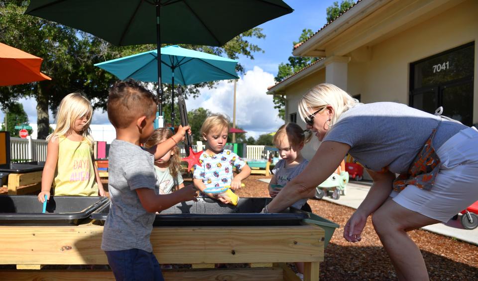  Baby Fox Academy teacher Debbie Mottaz, right, works with children in the 2 to3 year-old class as they explore a water sensory bin at the childcare center's new Lakewood Ranch location on Tuesday, July 12, 2022. 