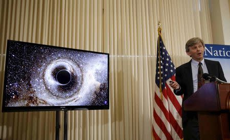 Dr. David Reitze, Executive Director of the LIGO Laboratory at Caltech, shows the merging of two black holes at a news conference to discuss the detection of gravitational waves, ripples in space and time hypothesized by physicist Albert Einstein a century ago, in Washington, DC, U.S. on February 11, 2016. REUTERS/Gary Cameron/File Photo