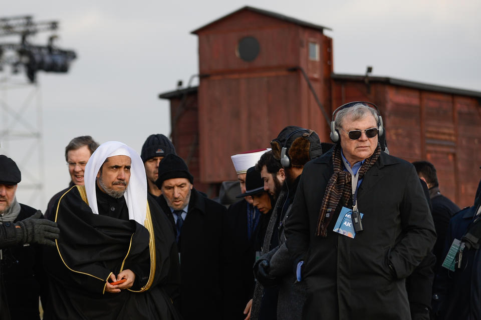 Sheikh Mohammed al-Eissa, secretary-general of the Muslim World League, walks inside the camp.