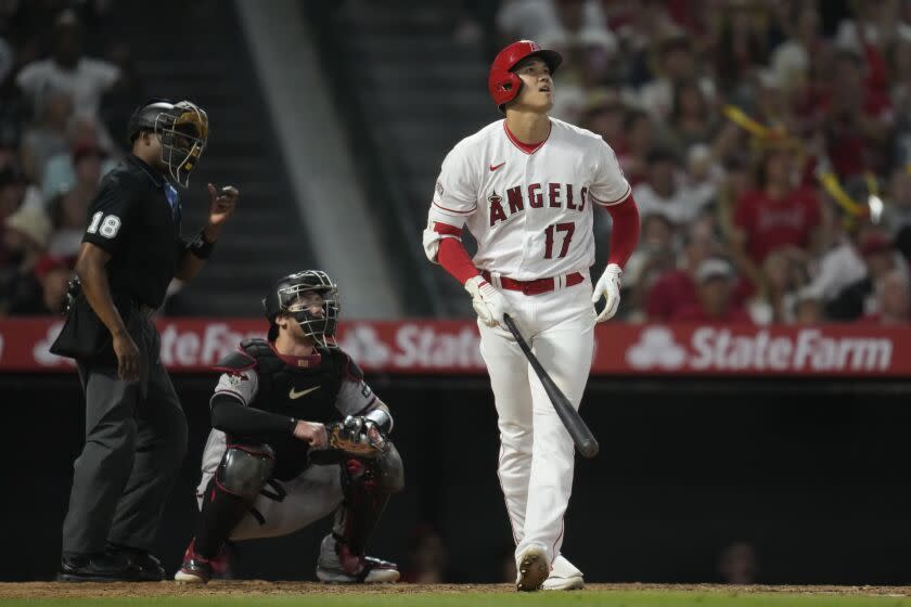 Shohei Ohtani looks up and reacts after hitting a deep home run during the Angels'  loss