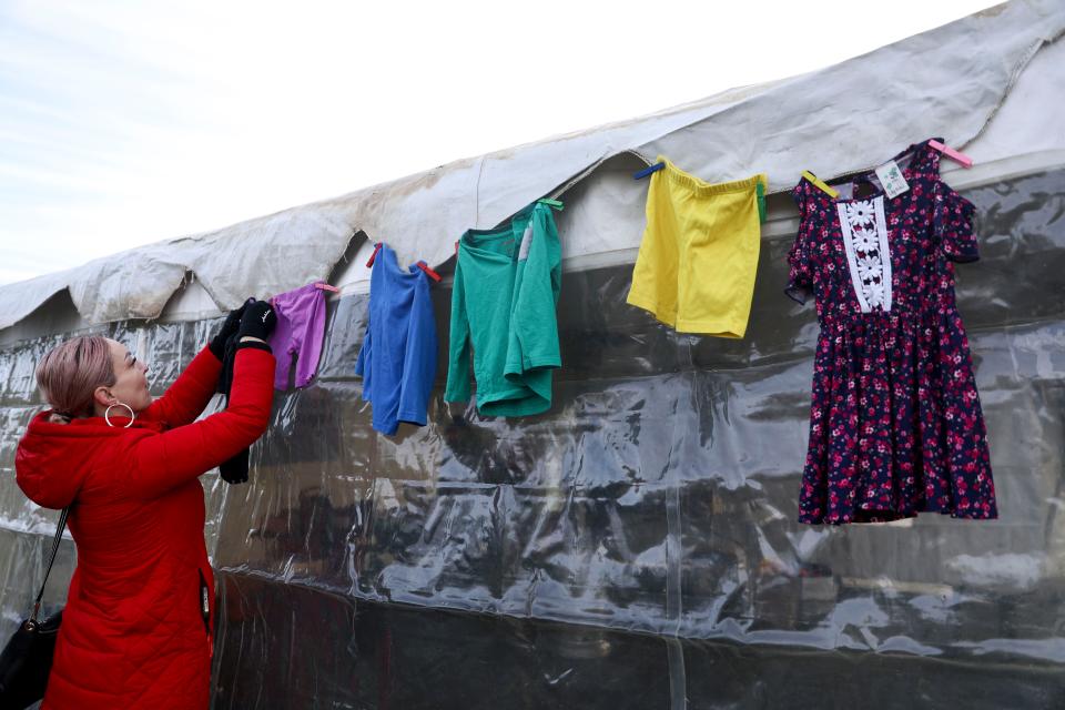 Marlina Campos with PCUN hangs children’s clothing to bring attention to the projected budget shortfall for Oregon's Employment Related Daycare program. More than 1,300 families are on a waitlist for the program