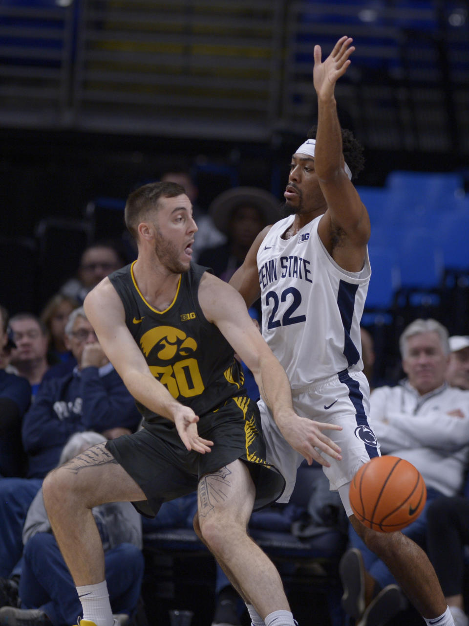 Iowa's Connor McCaffery (30) passes around Penn State's Jalen Pickett (22) during the first half of an NCAA college basketball game, Sunday, Jan. 1, 2023, in State College, Pa. (AP Photo/Gary M. Baranec)