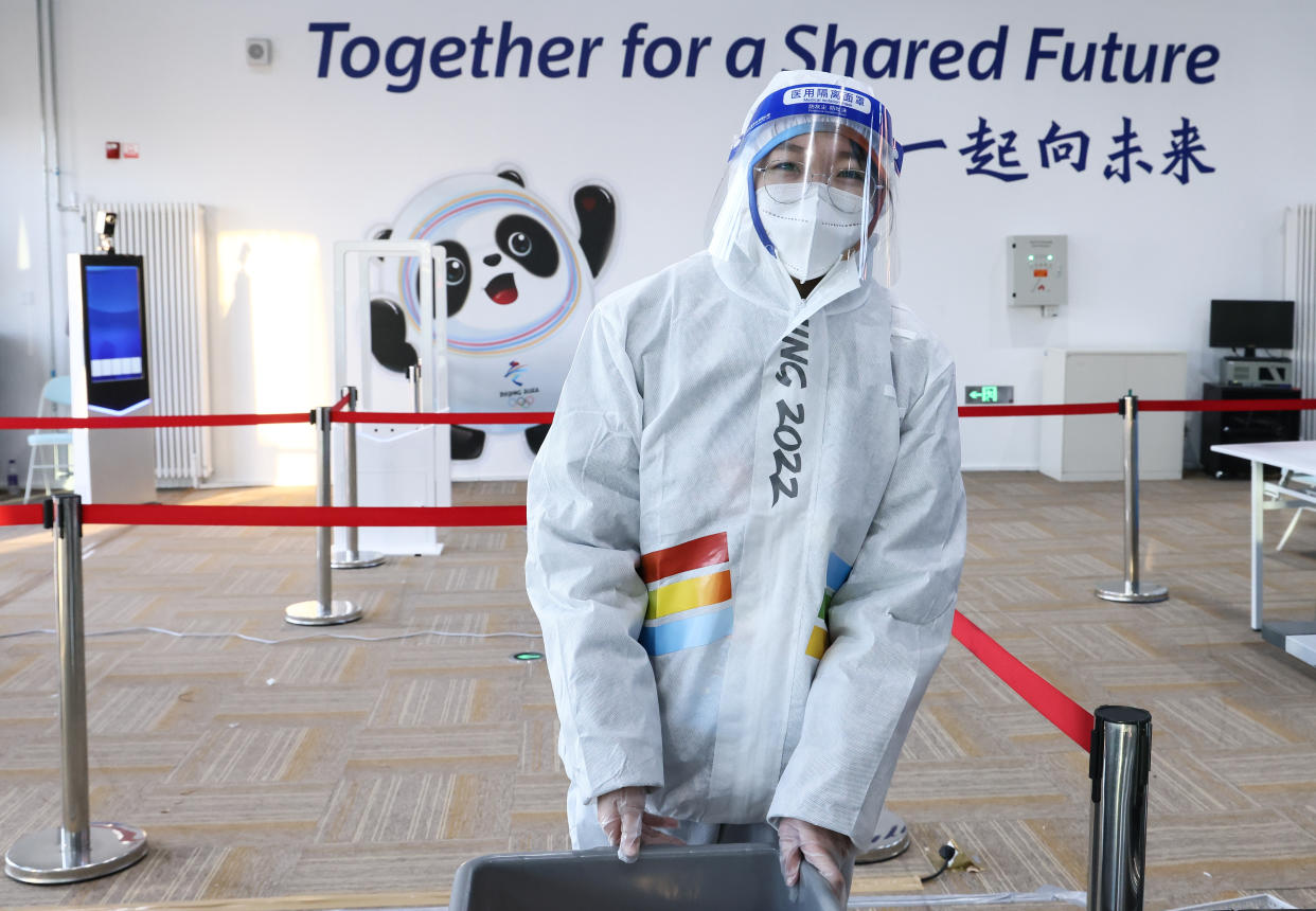 A security officer wearing protective gear is seen at a press center at the Olympic Village ahead of the 2022 Winter Olympic Games. (Valery Sharifulin\TASS via Getty Images)