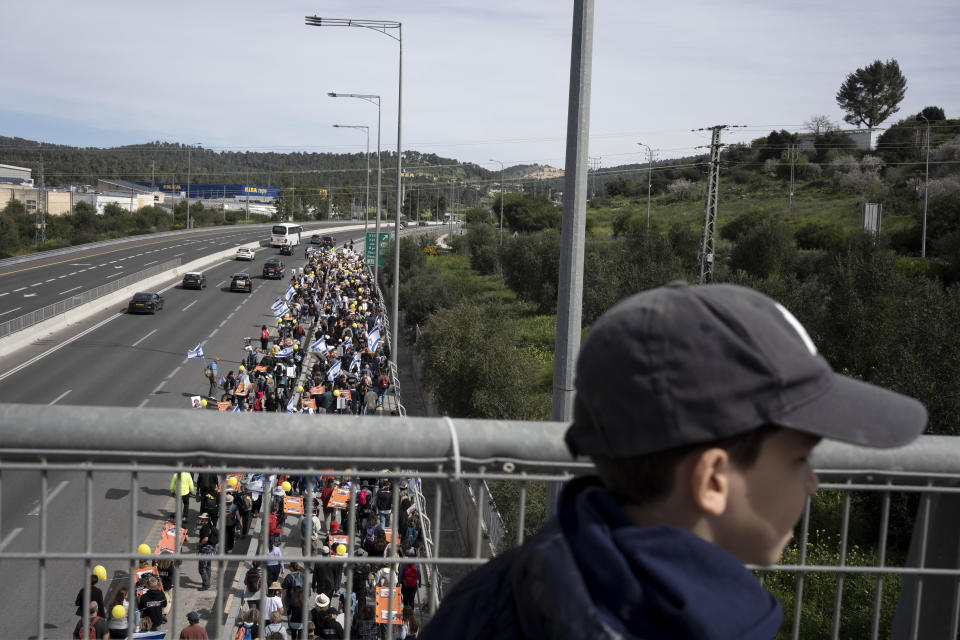 Families and supporters of hostages held captive by Hamas in the Gaza Strip begin their third day of a four-day march to Jerusalem to demand the immediate release of all hostages, in Beit Shemesh, Israel, Friday, March 1, 2024. (AP Photo/Maya Alleruzzo)