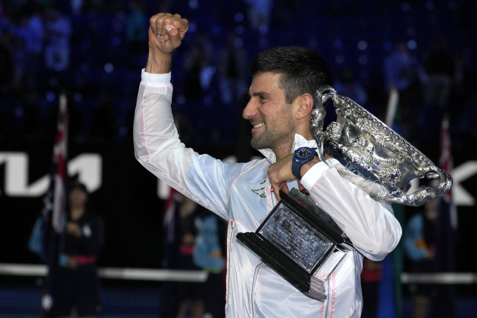 Novak Djokovic of Serbia gestures as he holds the Norman Brookes Challenge Cup after defeating Stefanos Tsitsipas of Greece in the men's singles final at the Australian Open tennis championship in Melbourne, Australia, Sunday, Jan. 29, 2023. (AP Photo/Aaron Favila)