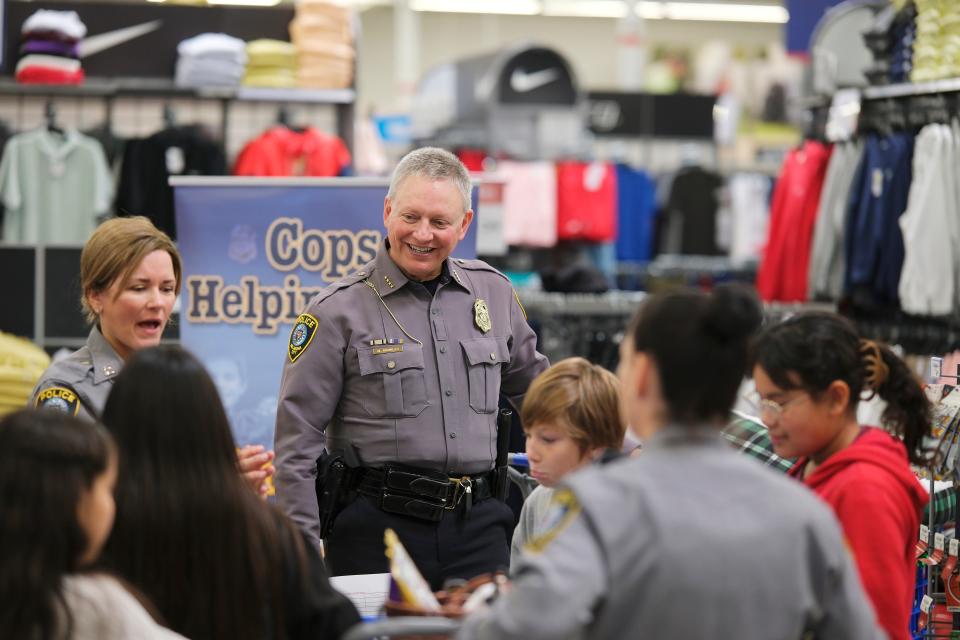 Oklahoma City police Capt. M. Henderson and Chief Gourley visit with students in 2023 during the annual Oklahoma City Police Athletic League "Shop with a Cop" event.