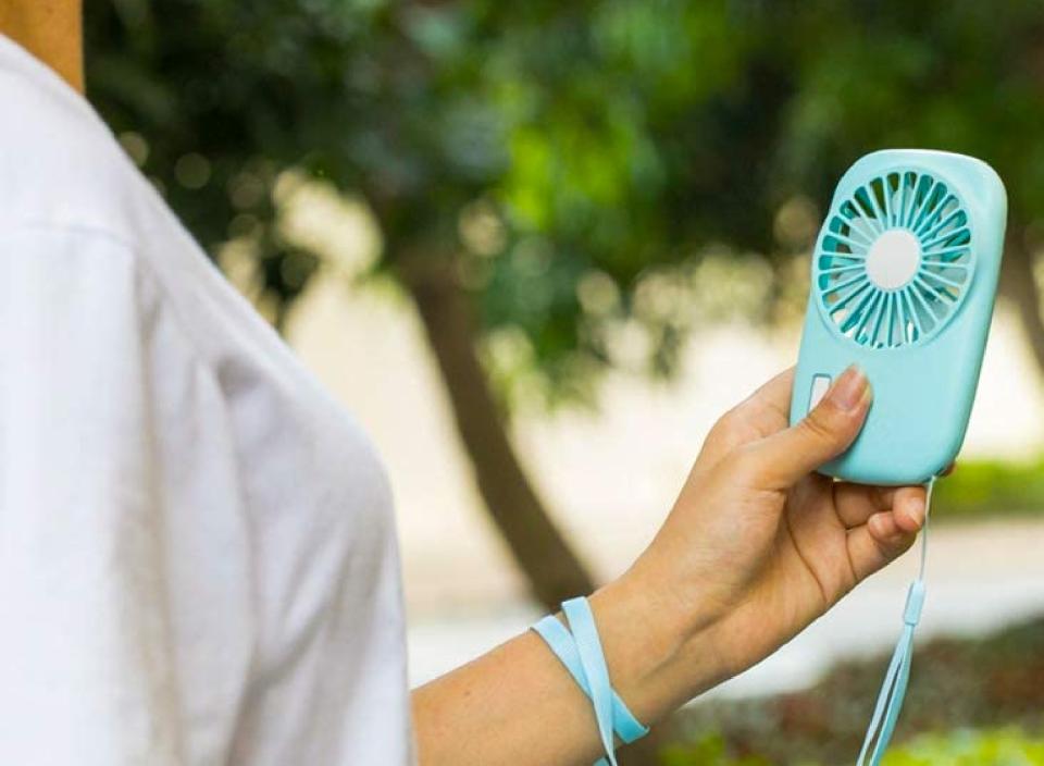 Bring a refreshing breeze wherever you go with this portable mini fan. (Source: Amazon)