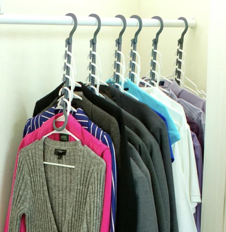 closet organizers filled with close hanging downward