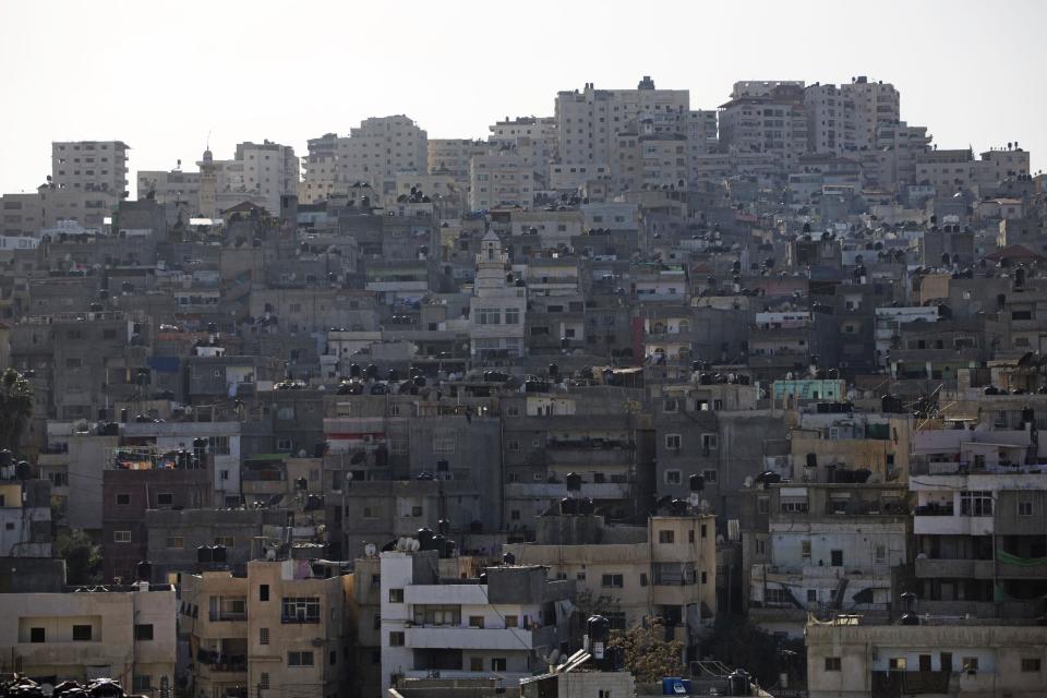 In this April 3, 2014 photo, water tanks are seen on rooftops in Shuafat in east Jerusalem. Tens of thousands of Palestinians in east Jerusalem have been without water for more than a month, victims of a decrepit and overwhelmed infrastructure and caught in a legal no-man’s land. Their district is technically part of Jerusalem municipality, but on the other side of the massive Israeli-built West Bank separation barrier, so Israeli services there are sparse yet Palestinian officials are barred for operating. With the scorching summer approaching, residents are growing increasingly desperate. (AP Photo/Sebastian Scheiner)