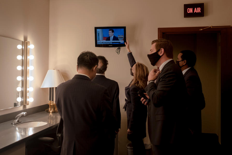 House managers watch the news as they prepare to speak to the press on Feb. 13, 2021.<span class="copyright">Gabriella Demczuk for TIME</span>