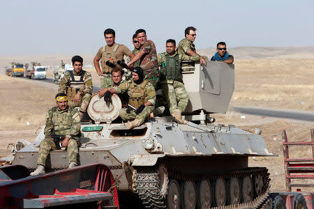 Peshmerga forces ride on military vehicles on the east of Mosul during preparation to attack Mosul, Iraq, October 15, 2016. REUTERS/Azad Lashkari