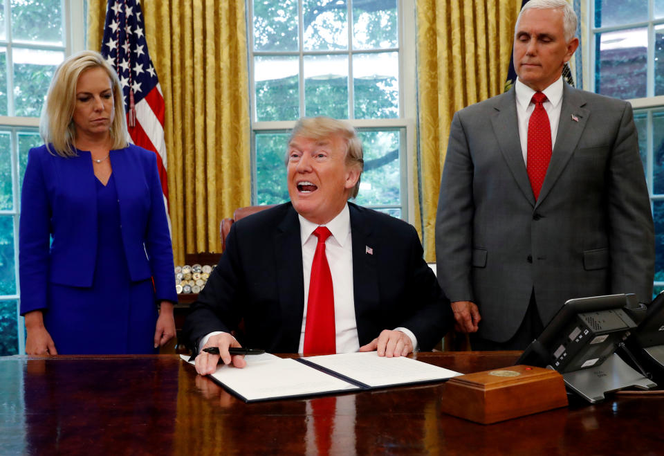 President Trump after signing an executive order on immigration policy, with DHS Secretary Kirstjen Nielsen and Vice President Mike Pence at his side, June 20, 2018. (Photo: Leah Milllis/Reuters)