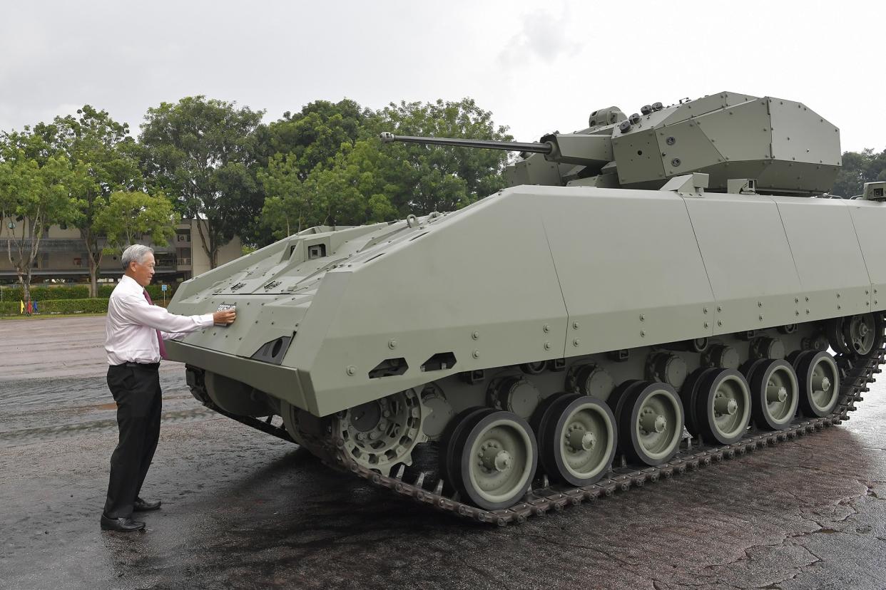 Dr Ng commissions the Hunter Armoured Fighting Vehicle by affixing the licence plate on the platform on 11 June, 2019. (PHOTO: Mindef)