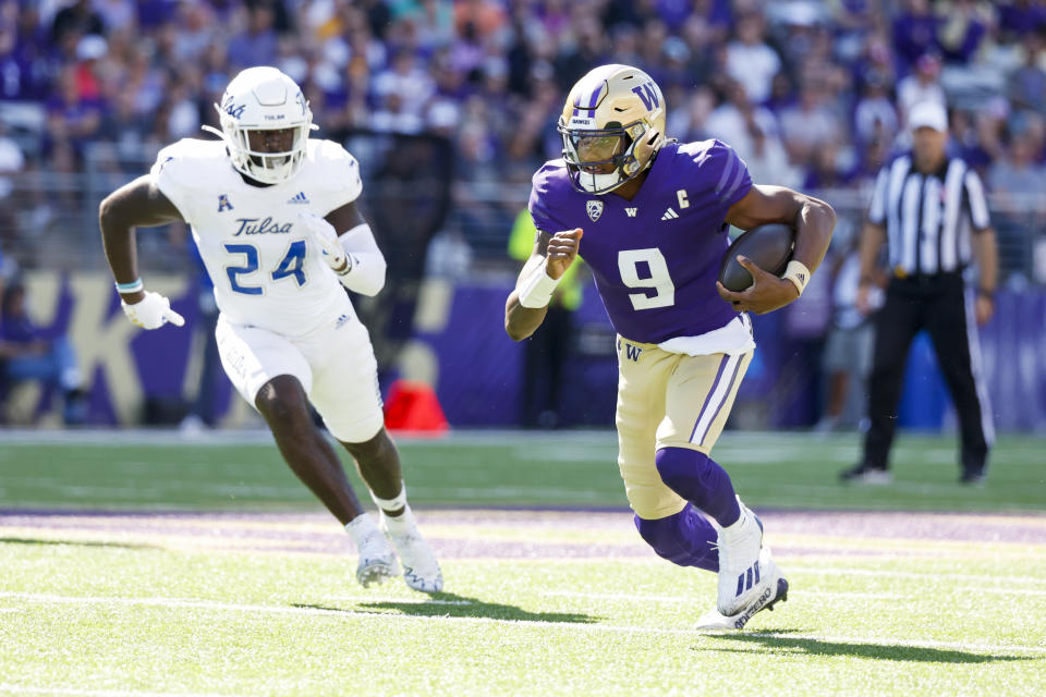 Sep 9, 2023; Seattle, Washington, USA; Washington Huskies quarterback Michael Penix Jr. (9) rushes against the Tulsa Golden Hurricane during the first quarter at Alaska Airlines Field at Husky Stadium. Mandatory Credit: Joe Nicholson-USA TODAY Sports