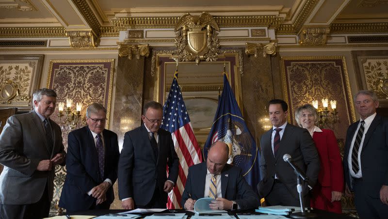 Utah Gov. Spencer Cox signs a record $400 million tax cut into law in the Gold Room at the Capitol on Wednesday.