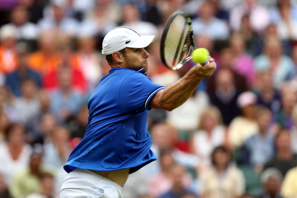 Andy Roddick of the United States returns a shot to Novak Djokovic of Serbia during the second round of Men's Singles Tennis on Day 4 of the London 2012 Olympic Games at Wimbledon on July 31, 2012 in London, England. (Photo by Clive Brunskill/Getty Images)