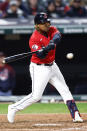 Cleveland Guardians' Jose Ramirez hits a single off Kansas City Royals relief pitcher Amir Garrett during the seventh inning of a baseball game, Monday, Oct. 3, 2022, in Cleveland. (AP Photo/Ron Schwane)