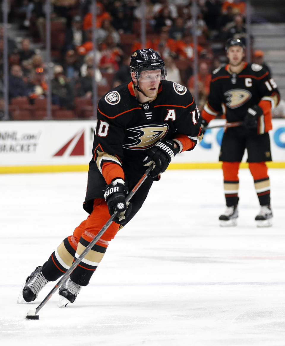 FILE - In this April 1, 2018, file photo, Anaheim Ducks' Corey Perry moves the puck during the second period of an NHL hockey game against the Colorado Avalanche in Anaheim, Calif. Joe Pavelski joined the Dallas Stars as an expensive free agent coming off one of his best goal-scoring years, while Corey Perry quietly signed a low-cost one-year contract after playing the fewest games of his career because of a knee injury. That’s where the differences end for a pair of veterans trying to help the Stars make back-to-back playoff trips for the first time in more than a decade.(AP Photo/Jae C. Hong, File)