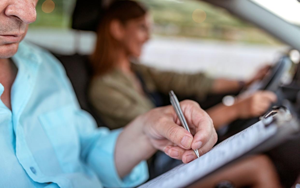 Young woman having a driving lesson