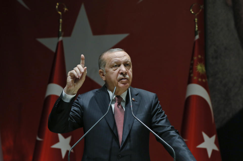 Turkey's President Recep Tayyip Erdogan talks to members of his ruling Justice and Development Party (AKP), in Ankara, Turkey, Friday, Oct. 26, 2018. The Saudi officials who killed journalist Jamal Khashoggi in their Istanbul consulate must reveal the location of his body, Erdogan said Friday in remarks that were sharply critical of the kingdom's handling of the case. (Presidential Press Service via AP, Pool)