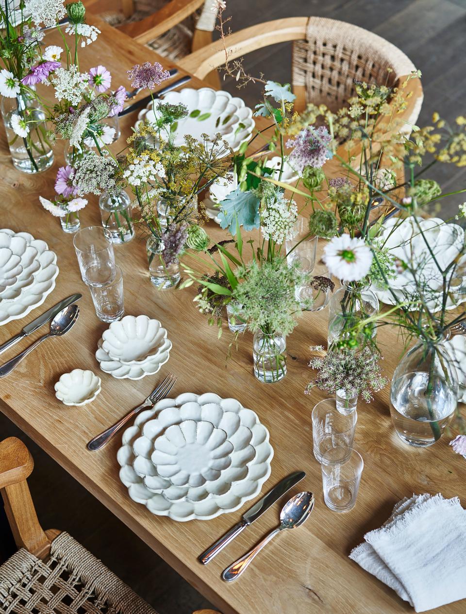 Kaneko Kohyo’s Rinka Flower Plate, Deborah Ehrlich glassware, Keiko Lee glasses and Yoshihiro Nishiyama bottles filled with Queen Anne’s lace and all other forms of culinary weeds, RW Guild Enzyme Washed linen napkins and tablecloth, Seamoor chairs, antique flatware. Flowers are by Emily Thompson.