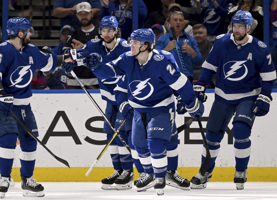Tampa Bay Lightning right wing Nikita Kucherov (86), center Anthony Cirelli (71), center Brayden Point (21) and defenseman Victor Hedman (77) celebrate Point's goal against the Buffalo Sabres during the first period of an NHL hockey game Thursday, Feb. 29, 2024, in Tampa, Fla. (AP Photo/Jason Behnken)