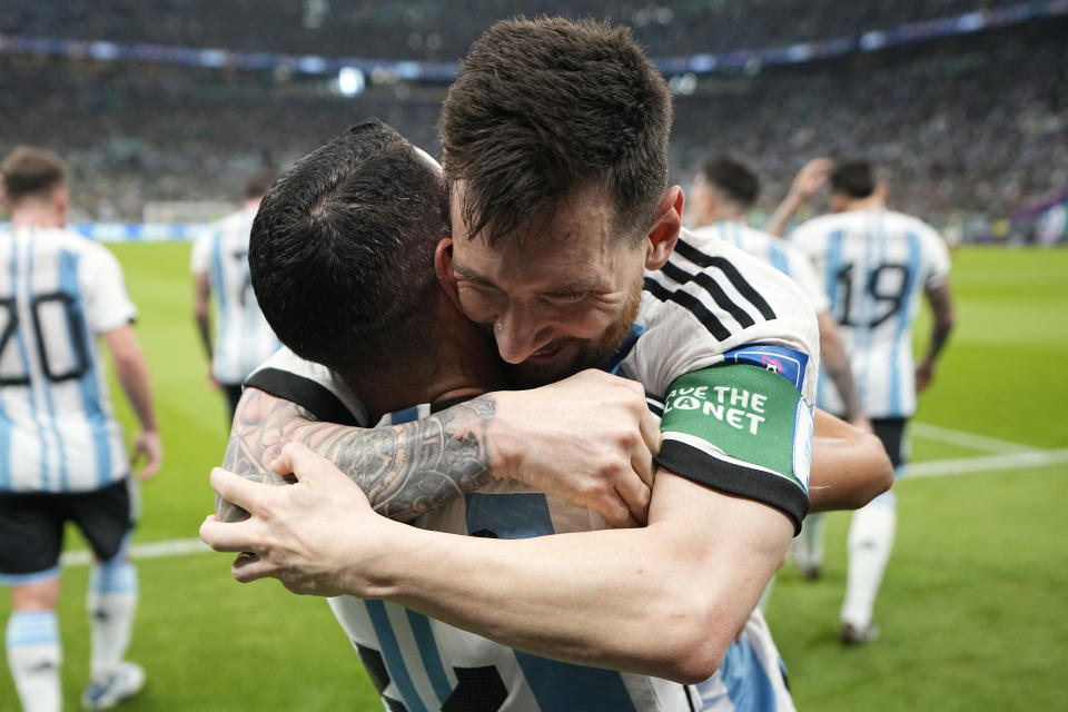 Argentina's Lionel Messi, right, celebrates with his teammate Angel Di Maria after scoring his side's opening goal during the World Cup group C soccer match between Argentina and Mexico, at the Lusail Stadium in Lusail, Qatar, Saturday, Nov. 26, 2022. (AP Photo/Ariel Schalit)