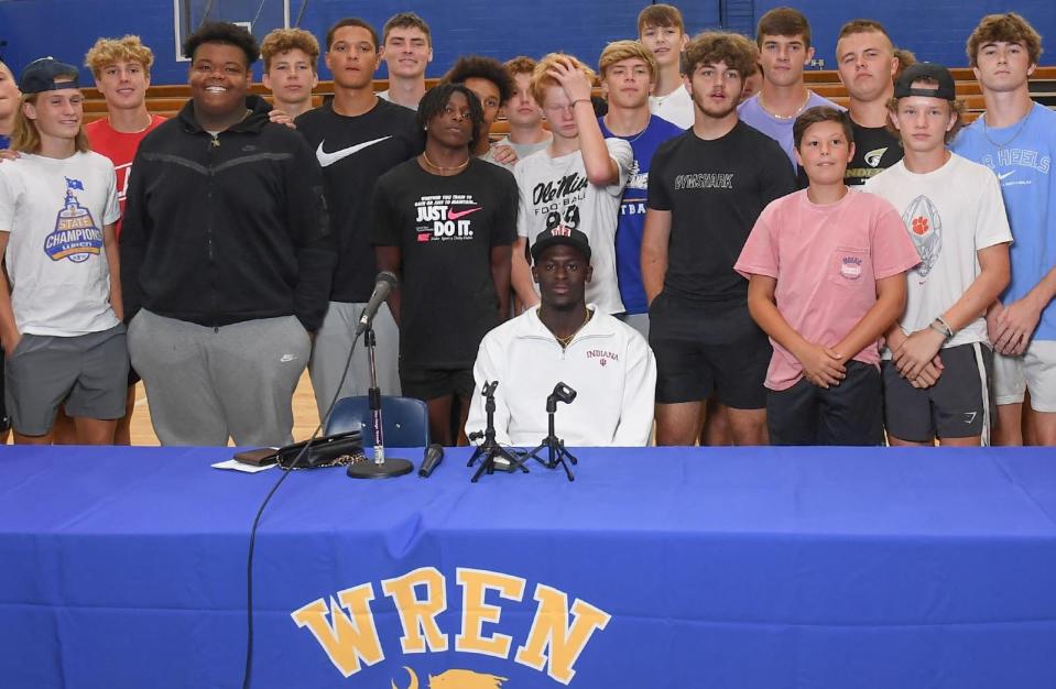 Travon West, middle, rising senior at Wren High School in Piedmont stands with teammates after committing to Indiana University football program during an announcement Wednesday, June 29, 2022. 