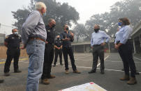 Representative Mike Thompson, director of Cal Fire Thom Porter, Governor Gavin Newsom, Senator Bill Dodd and Assemblywoman Cecilia Aguiar-Curry discuss the Glass Fire at Foothills Elementary School near St. Helena, Calif., Thursday, Oct. 1, 2020. (Christopher Chung/The Press Democrat via AP, Pool)